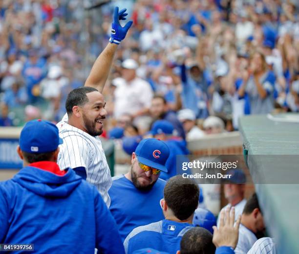 Rene Rivera of the Chicago Cubs gives a curtain call after hitting a grand slam against the Atlanta Braves during the second inning at Wrigley Field...