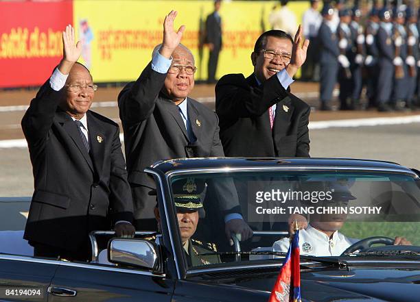 Cambodia's Senate president Chea Sim , Prime Minister Hun Sen , president of National Assembly aHeng Samrin wave to supporters during a People's...