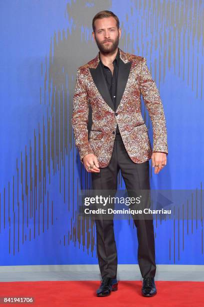 Alessandro Borghi walks the red carpet ahead of the 'Suburra. La Serie' screening during the 74th Venice Film Festival at Sala Giardino on September...