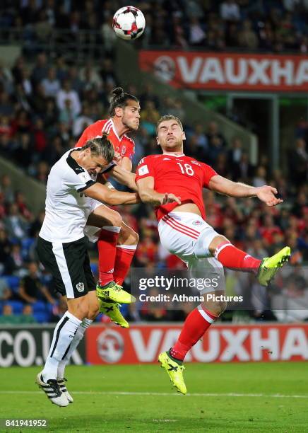 Gareth Bale of Wales and team mate Sam Vokes have their header attempt challenged by Sebastian Prodl of Austria during the FIFA World Cup Qualifier...