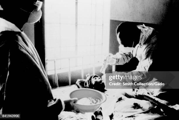 This doctor in a West African hospital is examining a Lassa fever patient, 1977. When the CDC began an in depth study of Lassa fever, it found that...