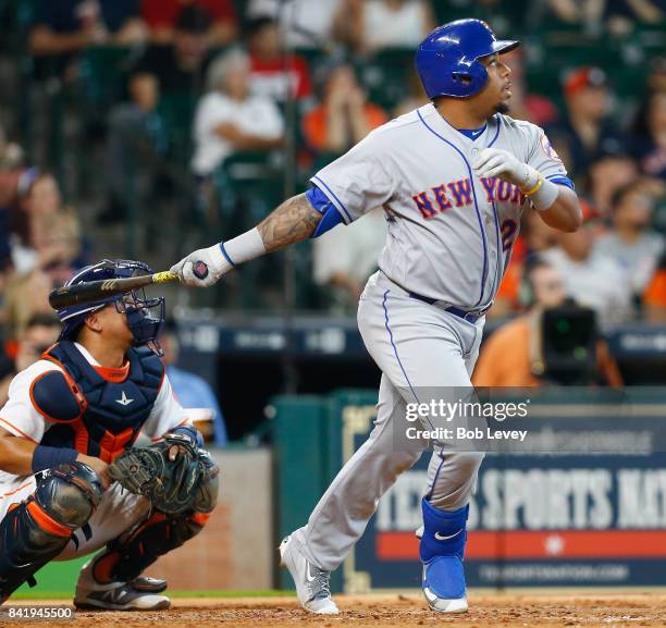 Dominic Smith of the New York Mets hits a home run in the fourth inning as Juan Centeno of the Houston Astros watches the ball at Minute Maid Park on...