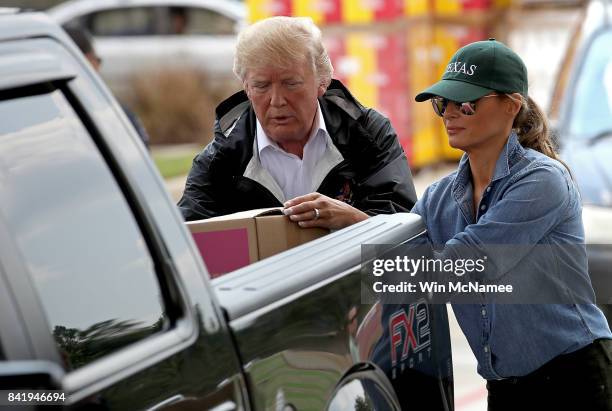 President Donald Trump and first lady Melania Trump load emergency supplies into the bed of a pickup truck for residents impacted by Hurricane Harvey...