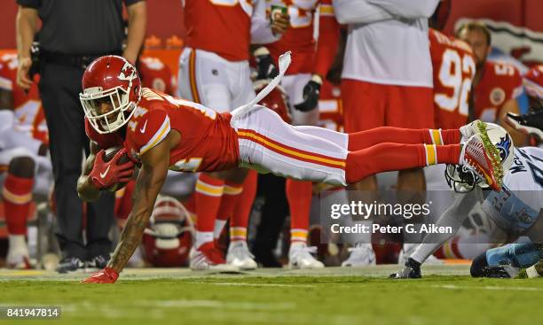 Wide receiver Demarcus Robinson of the Kansas City Chiefs catches a pass against defensive back Brice McCain of the Tennessee Titans during the first...