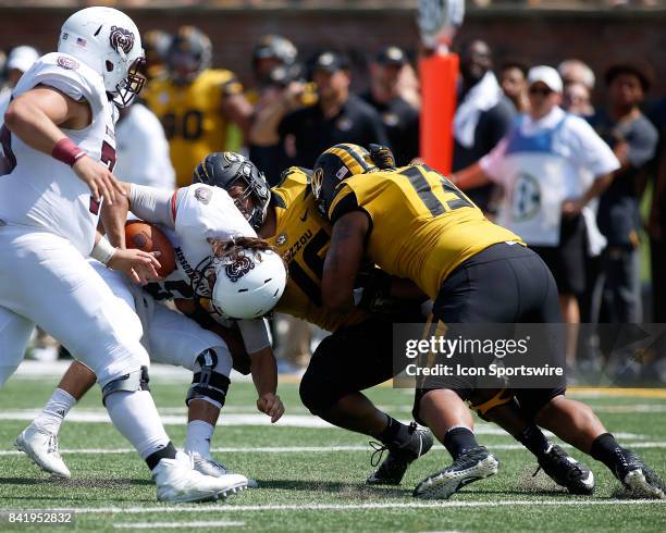 Missouri State Bears quarterback Peyton Huslig is sacked by Missouri Tigers defensive linemen Marcell Frazier and Rashad Brandon during the first...