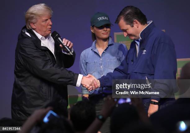 President Donald Trump, with first lady Melania Trump, greets Sen. Ted Cruz while visiting a volunteer center packing emergency supplies for...