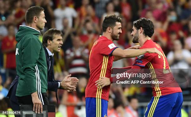 Spain's midfielder Isco cheers teammate Spain's forward David Villa, beside Spain's coach Julen Lopetegui , before leaving the field during the World...