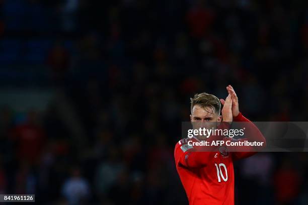 Wales' midfielder Aaron Ramsey applauds the fans at the final whistle of the FIFA World Cup 2018 qualification international football match between...