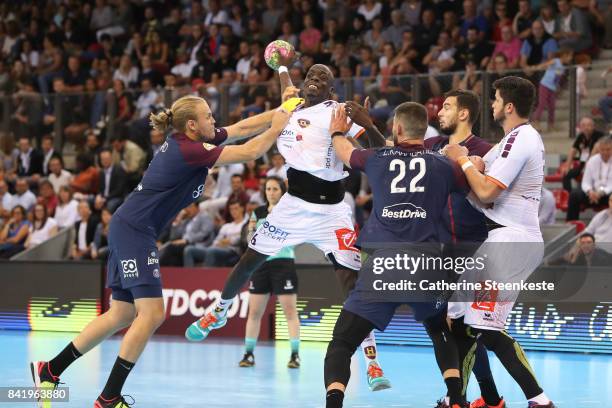 Olivier Nyokas of HBC Nantes is trying to shoot the ball against Henrik Mollgaard and Luka Karabatic of Paris Saint Germain during the Final of the...