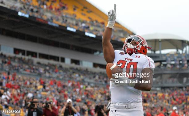 Christian Turner of the Youngstown State Penguins points to the sky after a 42 yard touchdown reception in the fourth quarter during the game against...