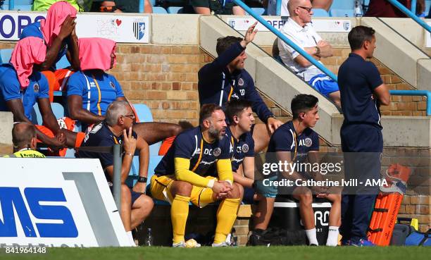 Goalkeeping coach Danny Coyne of Shrewsbury Town sits on the bench as reserve goalkeeper during the Sky Bet League One match between Gillingham and...