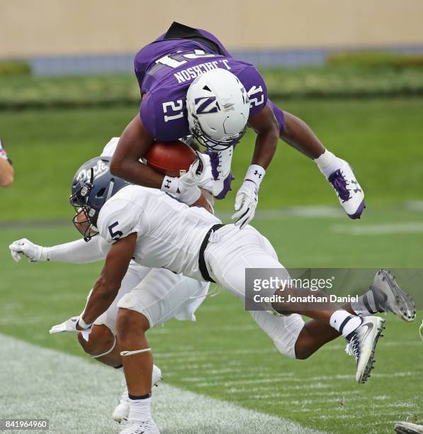 Justin Jackson of the Northwestern Wildcats flips in the air after being hit by Dameon Baber of the Nevada Wolf Pack at Ryan Field on September 2,...