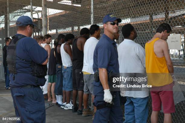 New OrleansGuards line up male prisoners before fenced bus gate makeshift intake cell at Greyhound Station, nicknamed Angola South, in mandatorily...