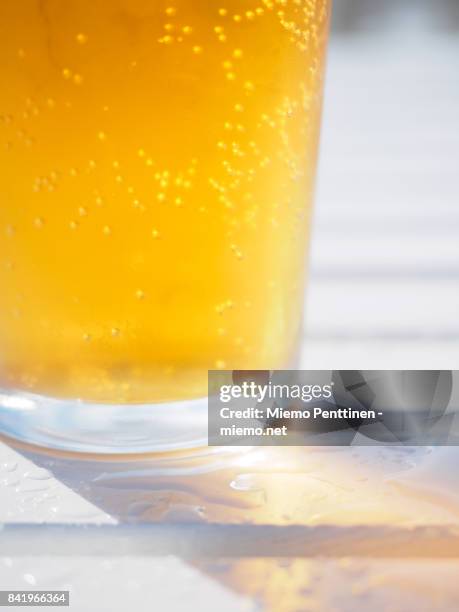 close-up of a sparkling glass of cider on a wet outdoor table at a bar - cidre photos et images de collection