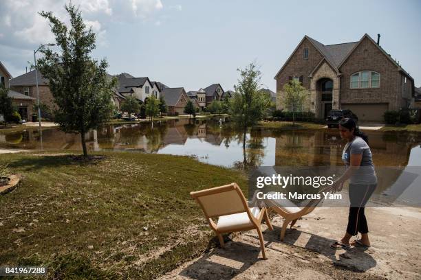 Local residents clear out damaged furniture in homes damaged in the aftermath of tropical storm Harvey, in the Millwood subdivision of Fort Bend...