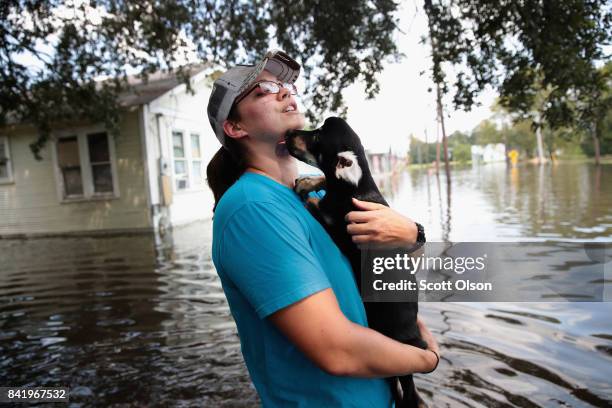 Marine veteran Megan Lowry with the Wounded Veterans of Oklahoma helps to rescue a puppy from a flooded home after torrential rains pounded Southeast...