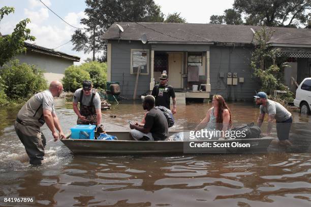 Members of the Wounded Veterans of Oklahoma help rescue flood victims after torrential rains pounded Southeast Texas following Hurricane and Tropical...