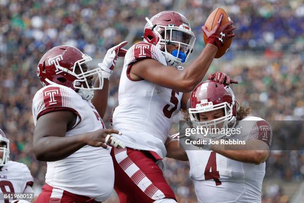 Keith Kirkwood of the Temple Owls celebrates with teammates after a 12-yard touchdown reception against the Notre Dame Fighting Irish in the second...