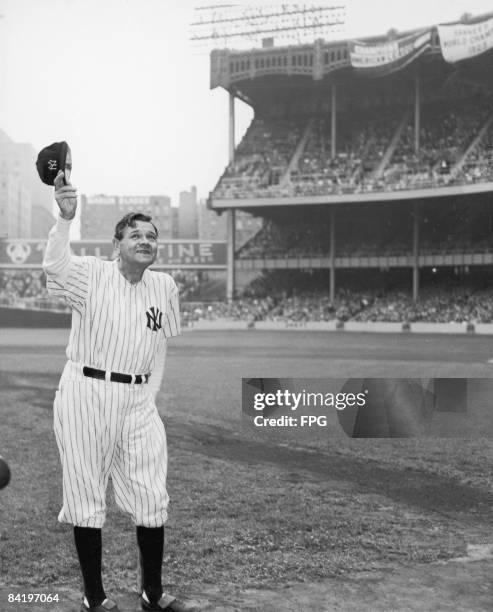 American baseball player Babe Ruth , dressed in his old New York Yankees number , waves to the crowd during a reunion of Yankee All-Stars at Yankee...