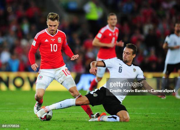 Wales Aaron Ramsey under pressure from Austrias Stefan Ilsanker during the FIFA 2018 World Cup Qualifier between Wales and Austria at Cardiff City...