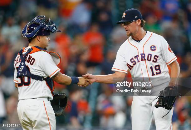 Tyler Clippard of the Houston Astros shakes hands with Juan Centeno after the final out as the Houston Astros defeated the New York Mets 12-8 at...