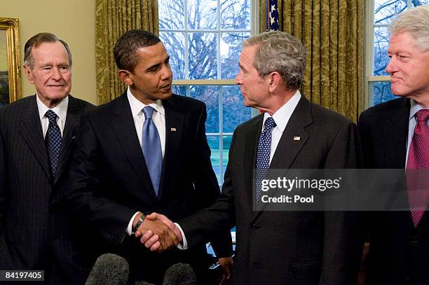 President George W. Bush shakes hands with President-elect Barack Obama , as former President Bill Clinton , and former President George H.W. Bush...