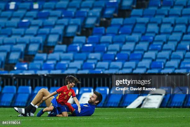 Gerard Pique of Spain plays with his son Milan Pique after the FIFA 2018 World Cup Qualifier between Spain and Italy at Estadio Santiago Bernabeu on...