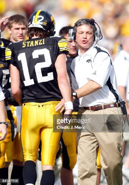 Head coach Kirk Ferentz of the Iowa Hawkeyes congratulates his players after a score against the South Carolina Gamecocks during the Outback Bowl at...