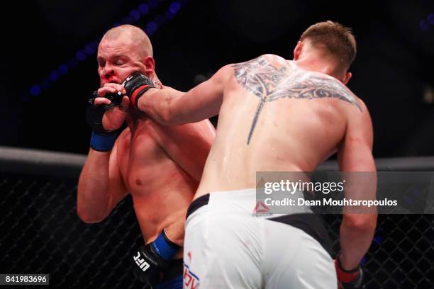 Alexander Volkov of Russia hits Stefan Struve of the Netherlands as they compete in their Heavyweight bout during the UFC Fight Night at Ahoy on...