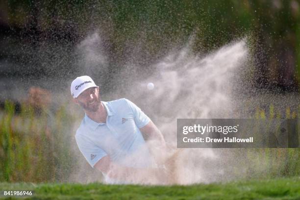 Dustin Johnson of the United States plays a shot from a bunker on the tenth hole during round two of the Dell Technologies Championship at TPC Boston...