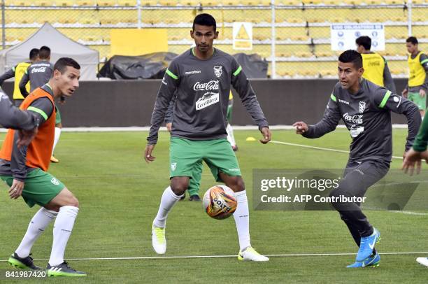 Bolivian players Pablo Escobar , Gilbert Alvarez and Juan Carlos Arce take part in a training session by the Bolivian national football team on...