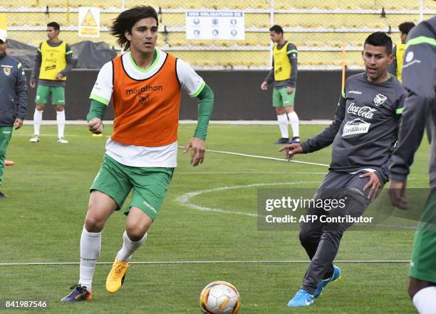 Marcelo Martins and Juan Carlos Arce take part in a training session of the Bolivian national football team on September 2 in the Hernando Siles...