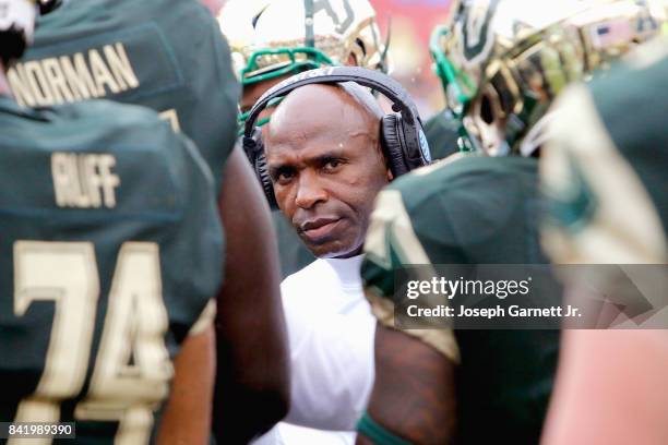 Head Coach Charlie Strong of the South Florida Bulls talks with his players during a timeout in the second quarter of their game against the Stony...