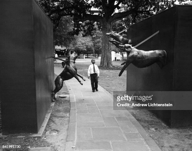 Young boy walks past a sculpture depicting a scene from when Civil Rights marchers were attacked by law enforcement dogs on February 22, 2012 at the...