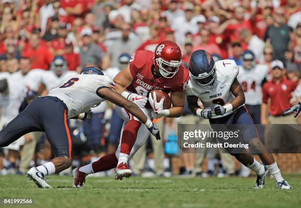 ZNORMAN, OK tight end Mark Andrews of the Oklahoma Sooners is hit by linebacker Dylan Parsee and defensive back Michael Lewis of the UTEP Miners at...