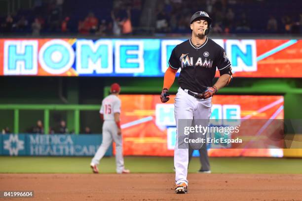 Giancarlo Stanton of the Miami Marlins rounds second base after hitting his 52nd home run of the season during the first season against the...