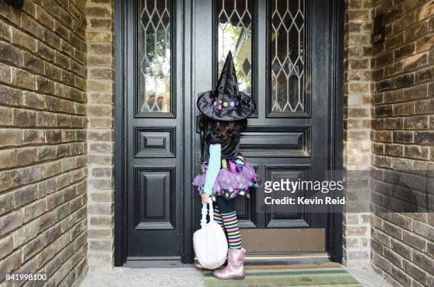 young girl dressed up for halloween. - girl doorbell stockfoto's en -beelden