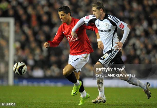 Derby County's English midfielder Steve Davies vies with Manchester United's Portugese midfielder Cristiano Ronaldo during the League cup semi final...