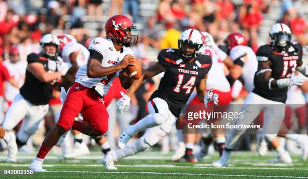 Eastern Washington quarterback Eric Barriere is chased by several Texas Tech defenders during the Texas Tech Raider's 56-10 victory over the Eastern...