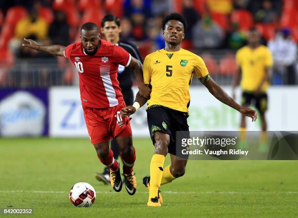 David Junior Hoilett of Canada is tackled by Alvas Powell of Jamaica during the second half of an International Friendly match at BMO Field on...