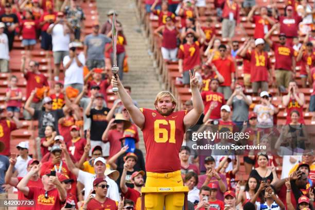 Jake Olson, who is blind, directs the band after playing in his first NCAA Football game between the Western Michigan Broncos and the USC Trojans on...