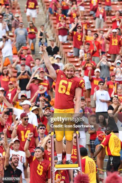 Jake Olson, who is blind, directs the band after playing in his first NCAA Football game between the Western Michigan Broncos and the USC Trojans on...