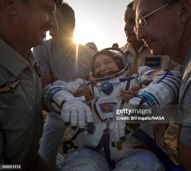 In this handout photo provided by NASA, Expedition 52 Roscosmos cosmonaut Fyodor Yurchikhin is helped out of the Soyuz MS-04 spacecraft just minutes...