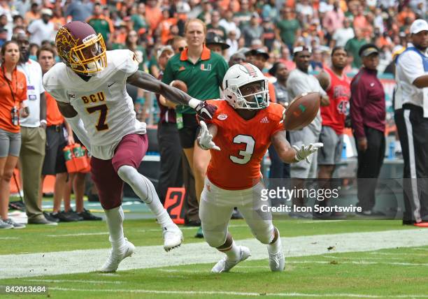 University of Miami wide receiver Mike Harley dives for the ball as he is guarded by Bethune defensive back Elliott Miller during an NCAA football...