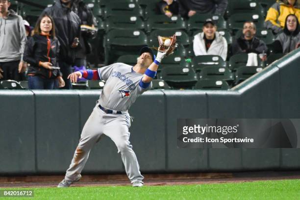 Toronto Blue Jays left fielder Steve Pearce fields a fly ball during an MLB game between the Toronto Blue Jays and the Baltimore Orioles on September...