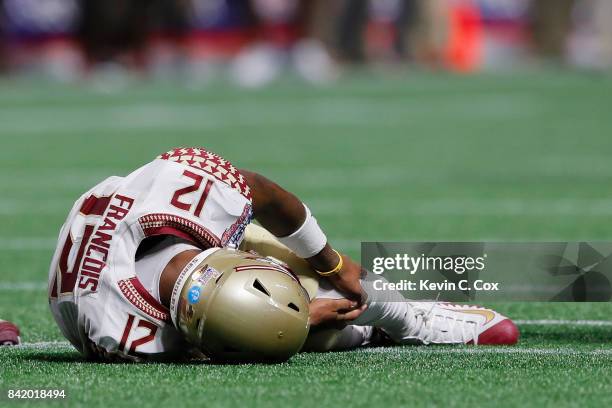 Deondre Francois of the Florida State Seminoles hold his left leg after being injured in the fourth quarter of their game against the Alabama Crimson...