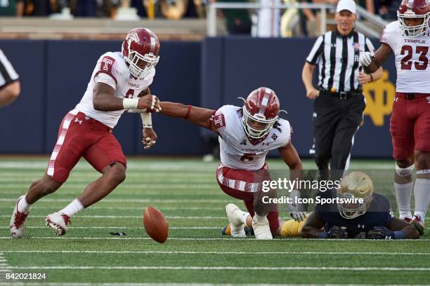 Temple Owls defensive lineman Sharif Finch and Temple Owls defensive back Delvon Randall battle to recover a fumble during the NCAA football game...