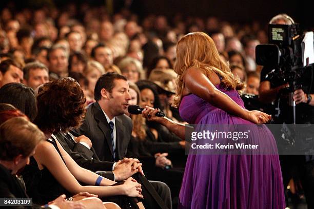 Host Queen Latifah speaks with actor Adam Sandler in the audience during the 35th Annual People's Choice Awards held at the Shrine Auditorium on...