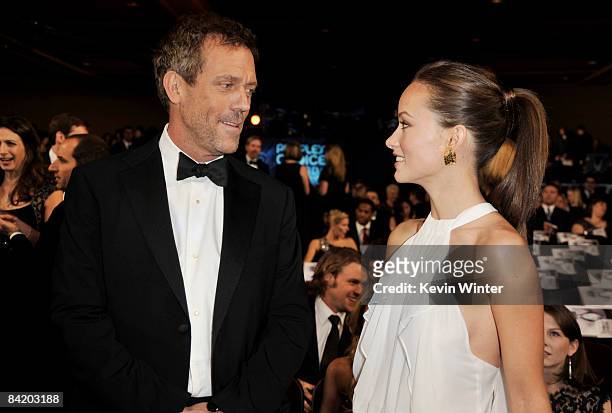 Actor Hugh Laurie and actress Olivia Wilde pose in the audience during the 35th Annual People's Choice Awards held at the Shrine Auditorium on...