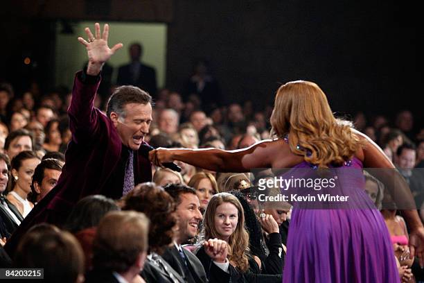 Host Queen Latifah speaks with actor Robin Williams in the audience during the 35th Annual People's Choice Awards held at the Shrine Auditorium on...